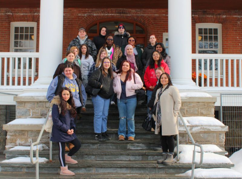 people standing on front steps of a building