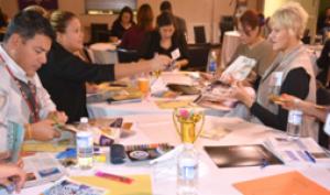 Participants creating group vision boards. Each table worked as a group. Each individual group presented their vision board
