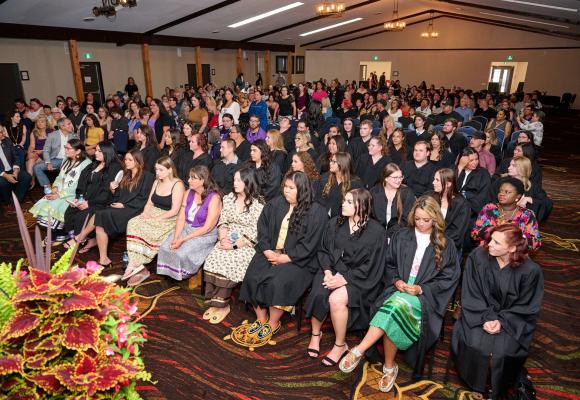 graduates seated in a hall