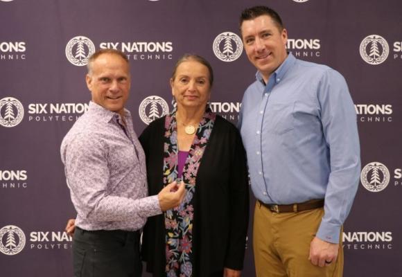 three people standing posing for a pic