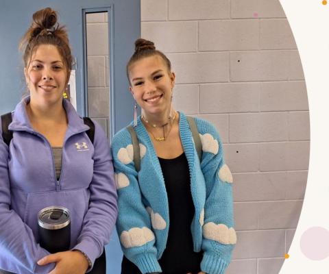 Two students smiling
