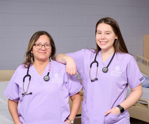 Two nursing students in scrubs