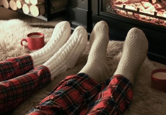 feet being warmed by a fire